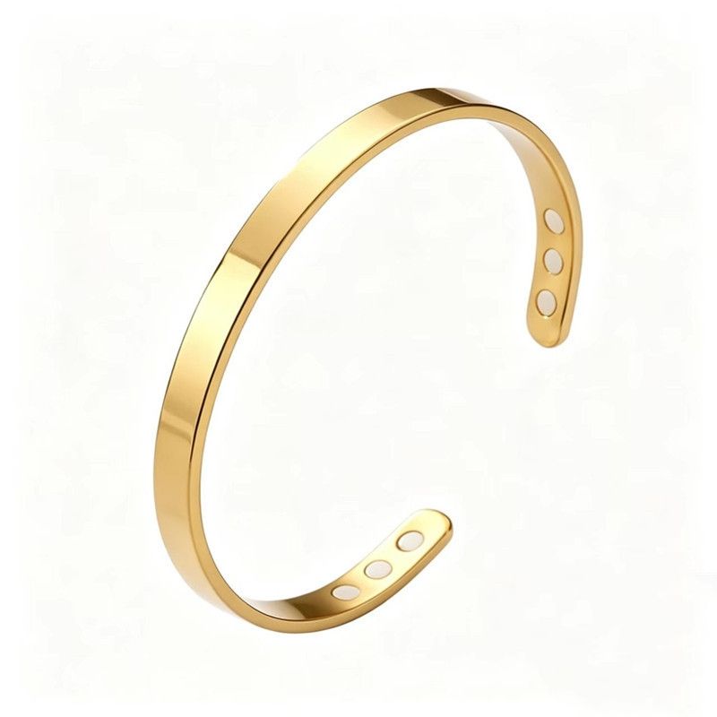 The bracelet in gold: a plain open steel cuff with six magnets set into the ends
