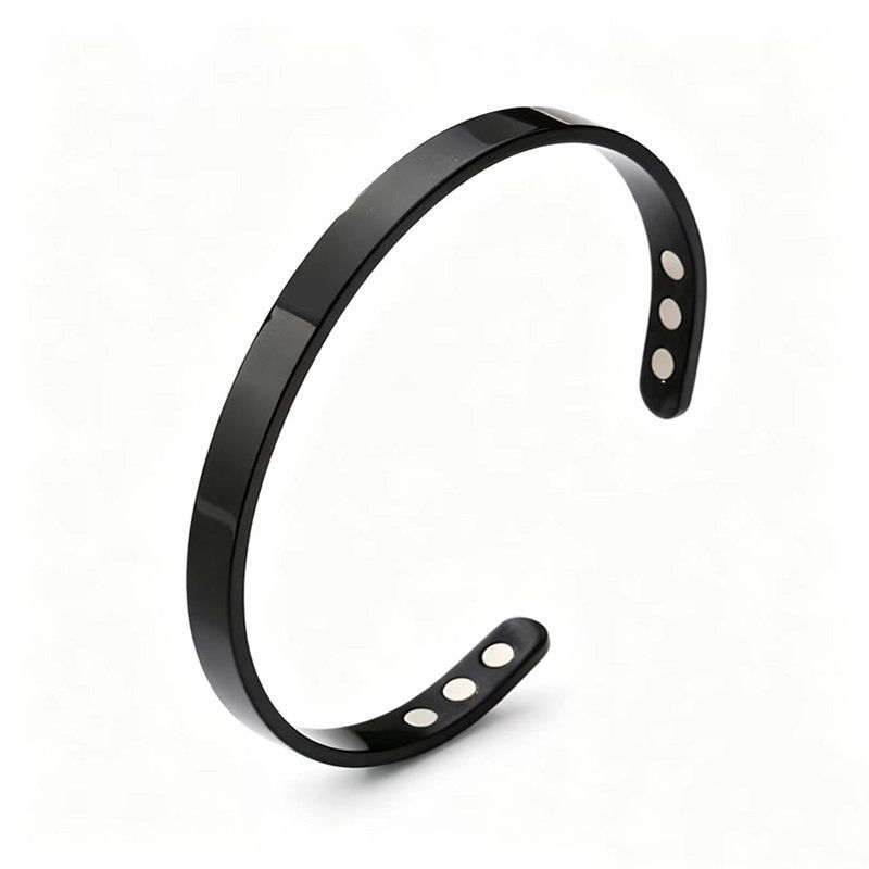 The bracelet in onyx black: a plain open steel cuff with six magnets set into the ends
