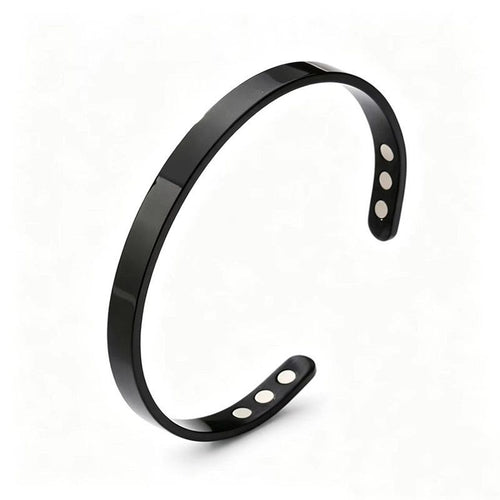 The bracelet in onyx black: a plain open steel cuff with six magnets set into the ends