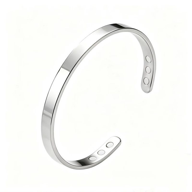 The bracelet in brushed steel: a plain open steel cuff with six magnets set into the ends